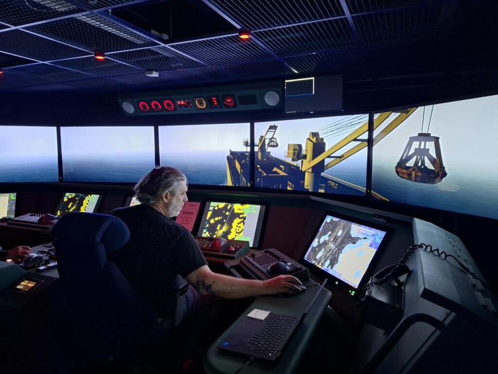 Captain steering a vessel in a simulation environment.